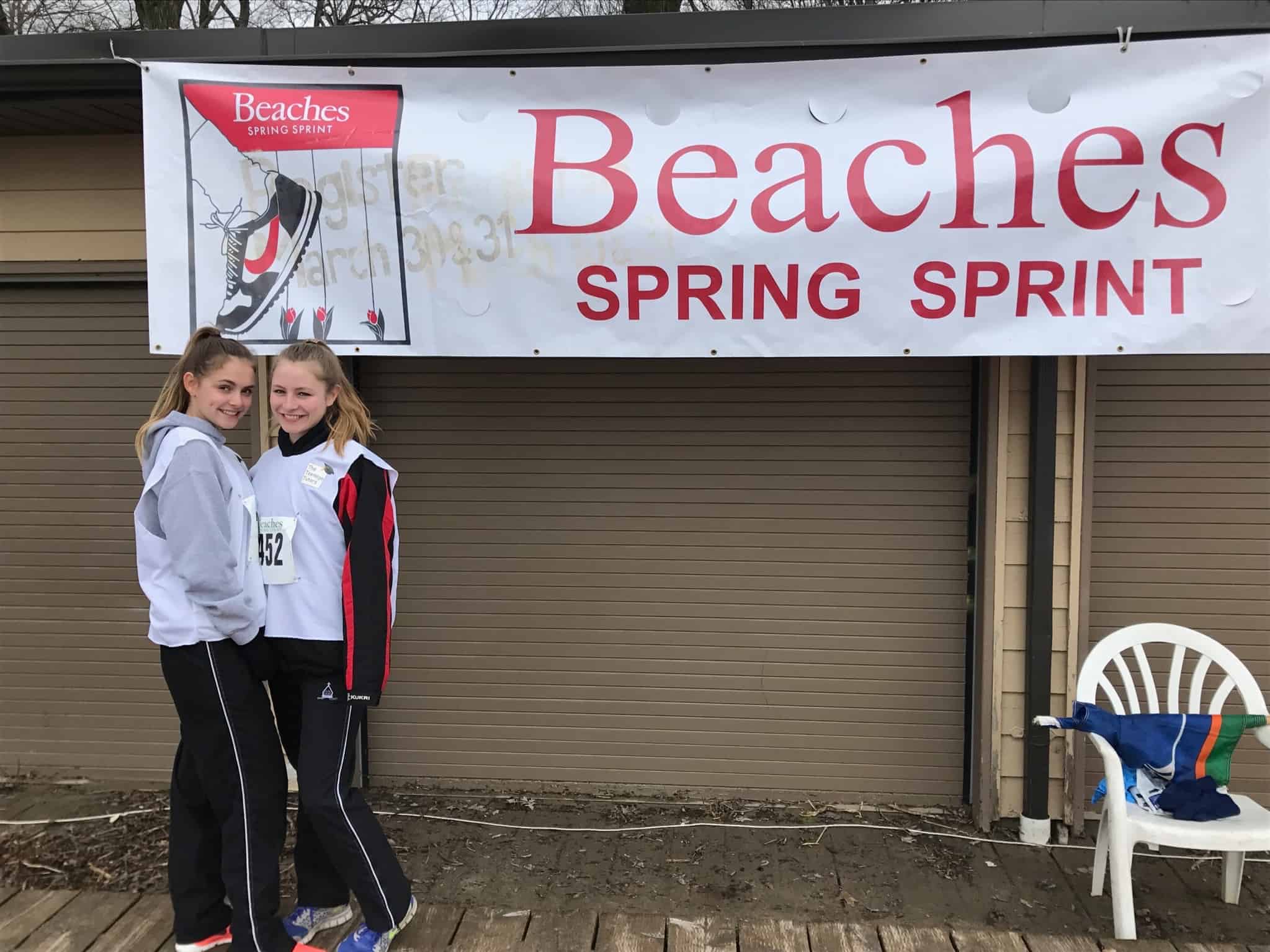 Tutors posing with the spring sprint banner