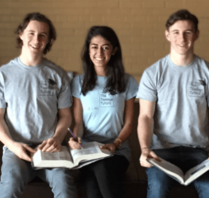 Three Tutors sitting with books opened