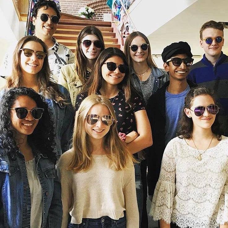 Tutors standing proudly wearing sunglasses